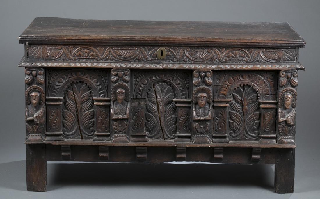 South Asian carved trunk / blanket chest.: A South Asian style trunk / blanket chest with fabric lined interior. Carved decorative details include side, and front panels decorated with carved animals, foliate designs, and raised on stump legs.