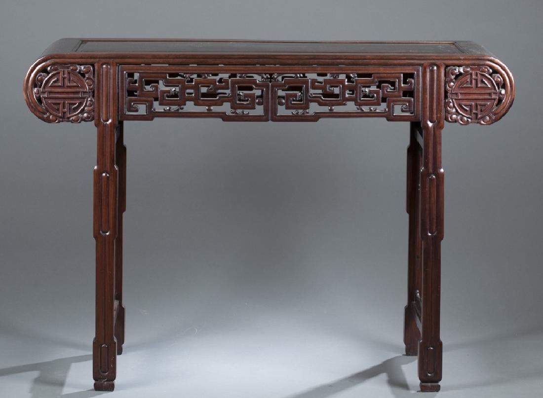 Chinese hardwood altar table.: A Chinese hardwood altar table. 19th/20th century. Hongmu wood. Rectangular table top with rounded ends on straight legs. Carved panels with "Shou" character motif in the center surrounded by Ruyi clo