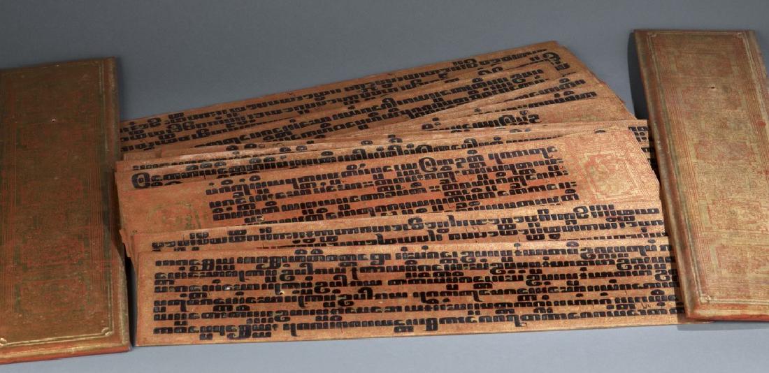 Set of 14 Burmese Pali manuscript.: A set of fourteen Pali Manuscript. Burmese Buddhist palm leaf Kammavacca. 20th century. Lacquered palm leaves with tamarind script written in black resin over red and gold ground with gold design on b