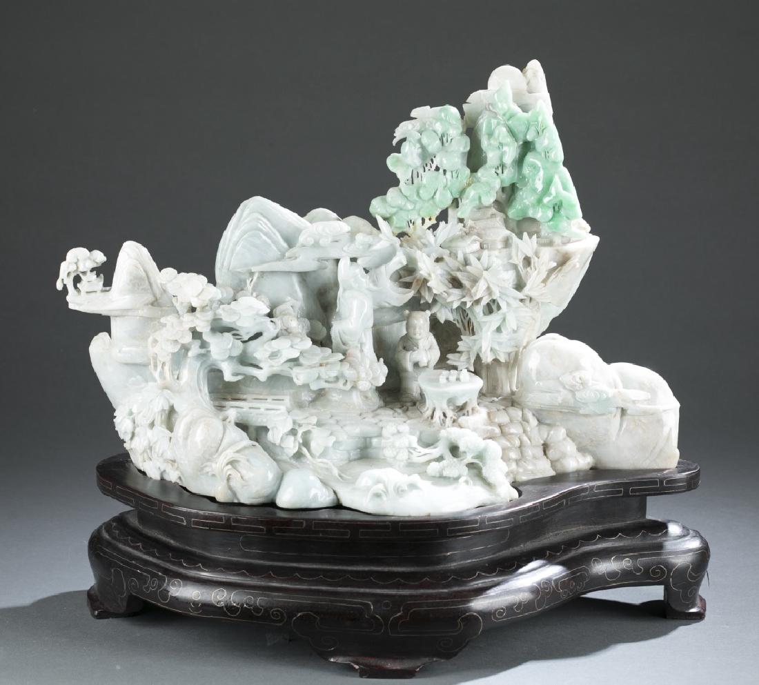 Large Chinese jadeite mountain.: A large Chinese jadeite mountain. Late 20th century. Apple green, light green, and white jadeite. Depicting mountainscape with bamboo grove, pine trees and other floral trees, surrounded with swirling