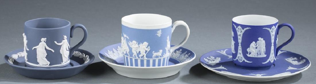 3 Wedgwood jasperware cups and saucers. 18th, 19th: A group of three Wedgwood jasperware cups and saucers. ++ Cup and saucer in dark blue and white. 2 3/4" x 5 1/4" x 2". ++ Coffee dancing hours cup and saucer in Portland blue and white. 1995. 2 1/2 x