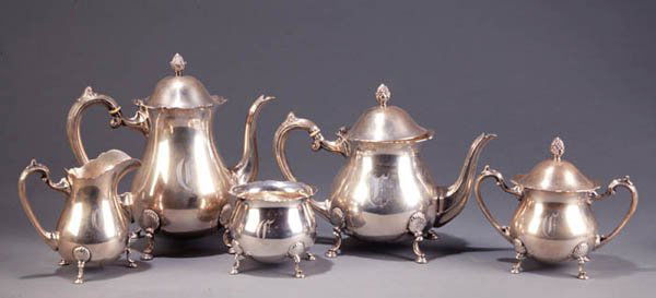 5-piece sterling silver coffee tea set: Five-piece sterling silver coffee and tea service by Fisher Silversmiths in the ''Jack Shepard'' pattern. Mid-20th century. Comprising: Coffeepot (9 1/2''h), teapot (8''h), creamer (5 1/4''h), sugar w