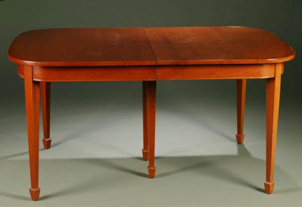 Federal style mahogany dining table.: Federal style mahogany dining table. c.1940. Having a rectangular top with rounded corners and supported by six tapering legs on spade feet. Includes three leaves. 30''h x 60''w (closed), 108''w (open