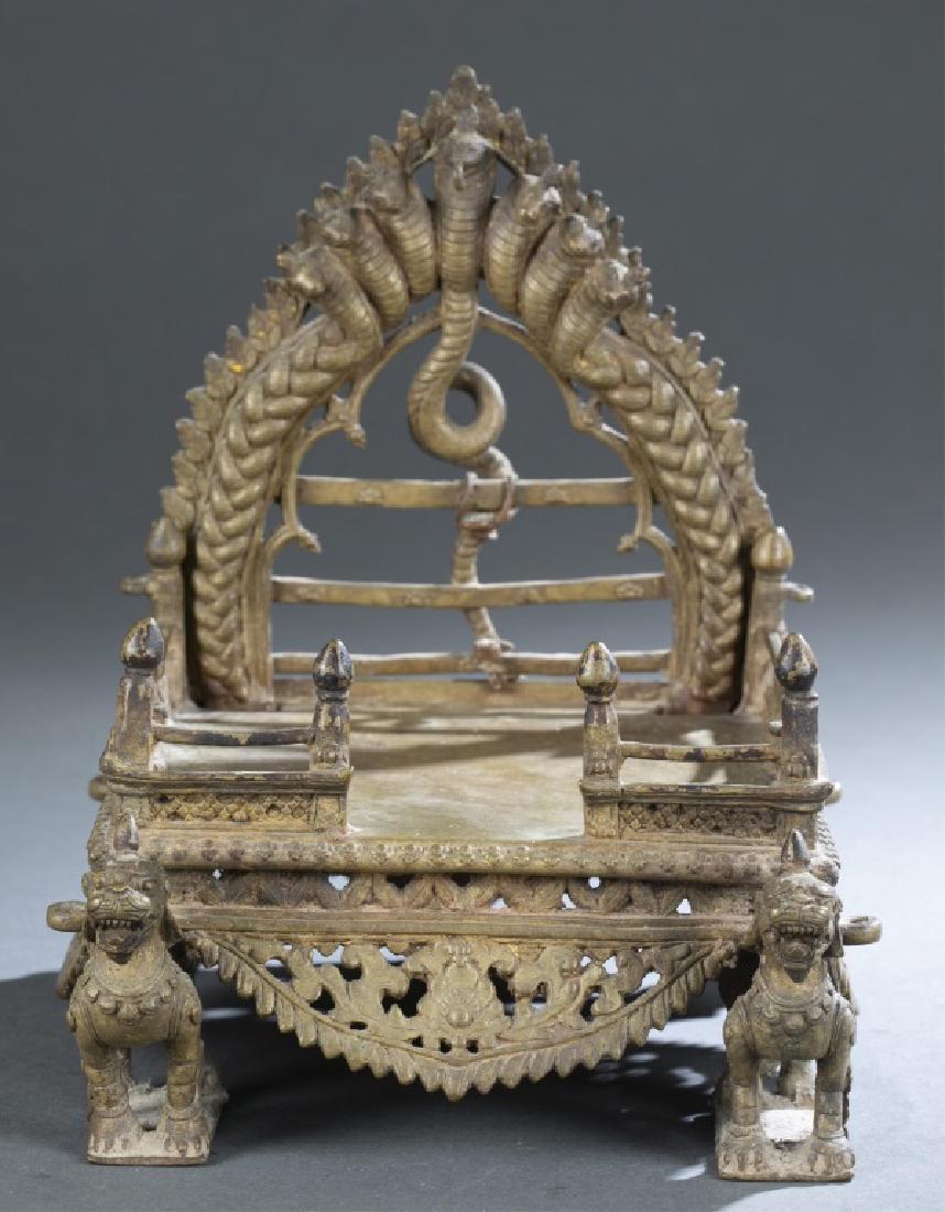 Southeast Asian Naga throne.: A Southeast Asian Naga throne. Square base with gallery top, having mythical beast feet with floral apron in openwork design. Having seven-headed snake Naga halo panel to the back. 9" x 8" x 7".Proven
