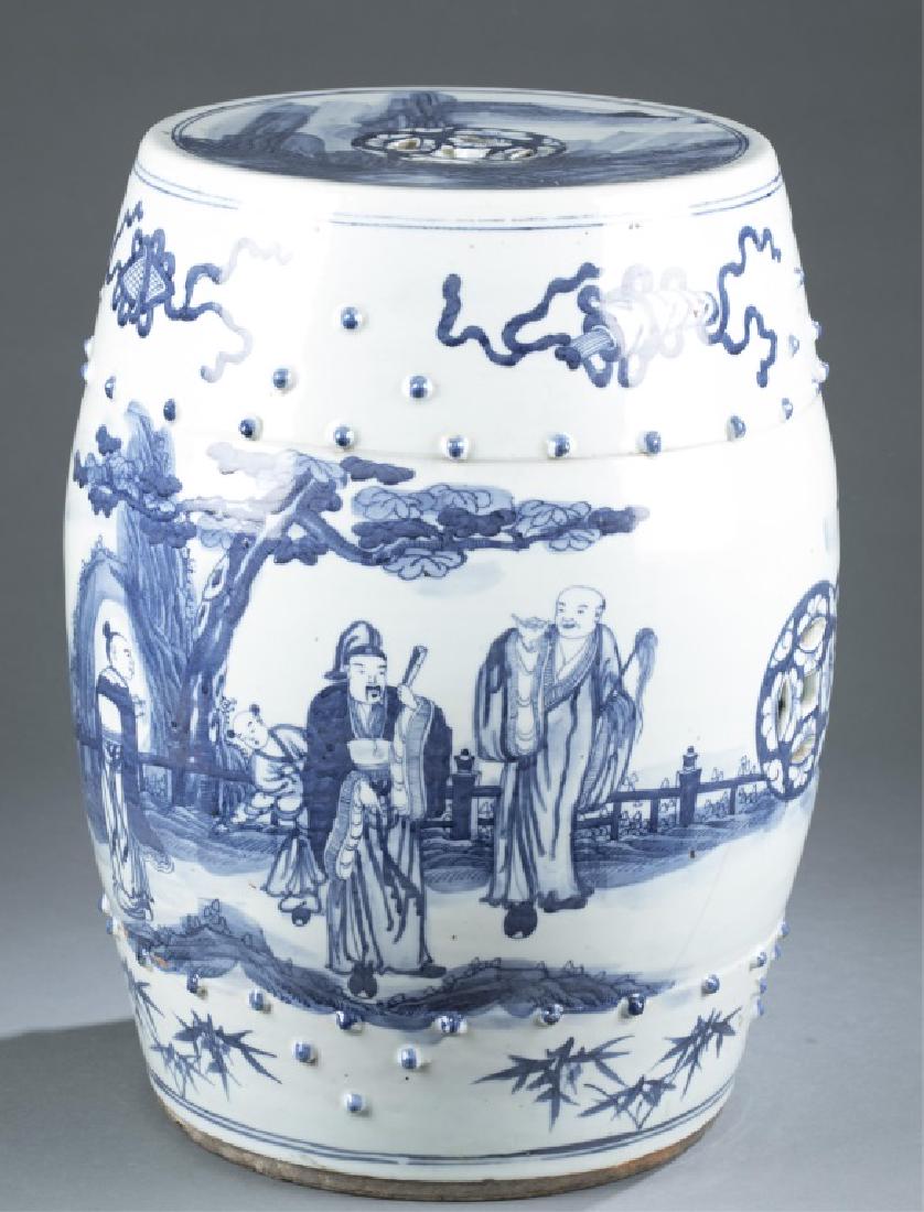 Chinese blue and white porcelain garden stool.: A Chinese blue and white porcelain garden stool. 19th/20th century. Drum form. Depicting immortals in a garden scene, with coin motif in openwork design to the sides, decorated with scholar's objects 