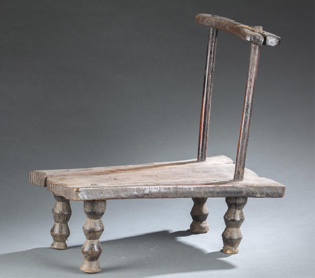 Liberian wooden chair. 20th century.: A rectangular shaped chair with a simple curved back Liberia. 20th century. 19 1/4" x 10 1/2" x 18 3/4."_x000D_ Provenance: Inventory and Collection from the Estate of Merton D. Simpson.