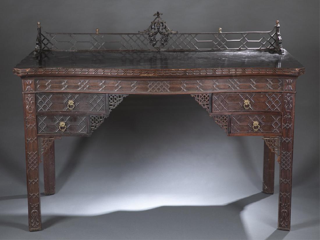 Edwardian, Chinese Chippendale Style, Sideboard.: An Edwardian, Chinese Chippendale Style, Mahogany Sideboard. circa 1901-1910. Pierced fretwork backsplash and canted-corner serpentine top above two reverse-graduated drawers, raised on square chamfer