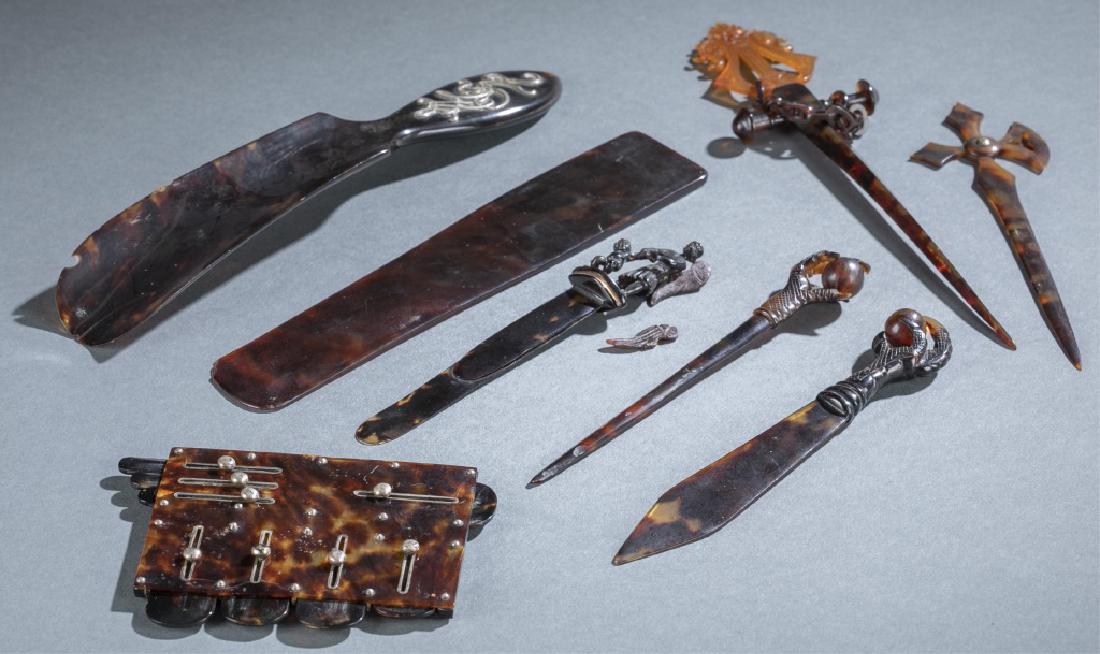 8 pieces of Tortoise Shell.: A group of eight pieces of Tortoise Shell. 19th/20th century. Includes shoe horn, page holder, two letter openers (one with broken angel wing), three hair pins, and sliding measurement device.