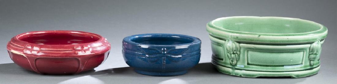 3 Art Pottery pieces, 20th century.: A group of three Art Pottery pieces. 20th century. Probably American. ++ Small blue glaze bowl. Illegible mark on bottom. 2" x 5". ++ Red glaze low bowl. Marked "B.58" on bottom. 2" x 6 3/4". ++ Green