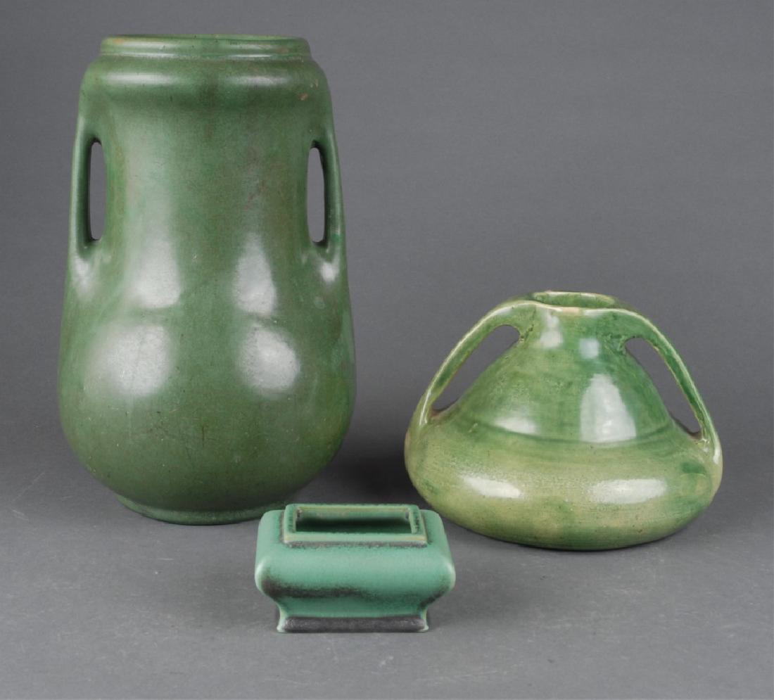 3 green glaze pieces, 20th century.: A group of three green glaze pieces. 20th century. probably American. ++ Two double-handle vases. Marked on bottom. Largest: 10 3/8" x 6 1/2". Smallest: 4 5/8" x 7 1/8". ++ Teco dish. Marked on bottom
