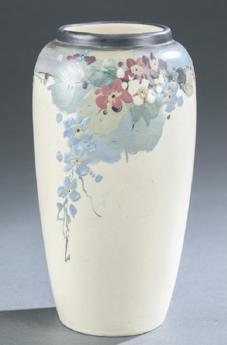 Weller Pottery, Hudson, floral vase, c. 1920s.: A Weller Potter Hudson line floral vase. Circa 1920s. Ohio. Glazed and hand painted blue and purple floral decoration on a cream body. 1" chip to ceramic body near base. Marked on bottom "Weller". 9"