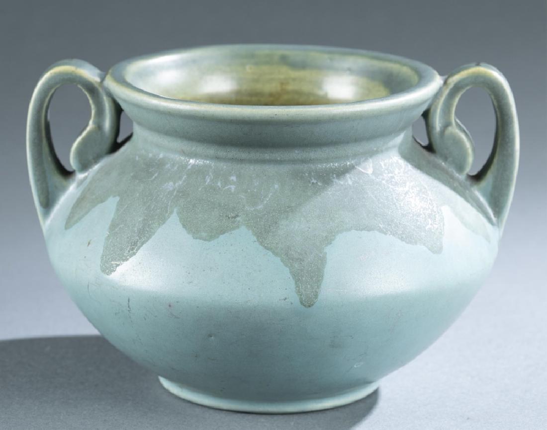 Roseville Pottery, Carnelian jardiniere c. 1910-15: A Roseville Pottery Carnelian line jardiniere. 1910-1915. Ohio. Bulbous-shaped two-handle jardiniere with a blue body and a darker blue over drip glaze. Designed by Harry W. Rhead. Marked on bottom. 5