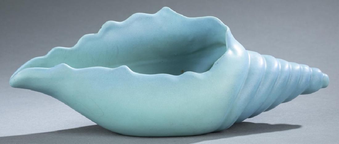 Van Briggle Pottery conch shell, 20th century.: A Van Briggle Pottery conch shell with blue matte glaze. 20th century. Colorado Springs, Colorado. Wear and staining consistent with age and use. Marked on bottom with the manufacturer mark and "26, V