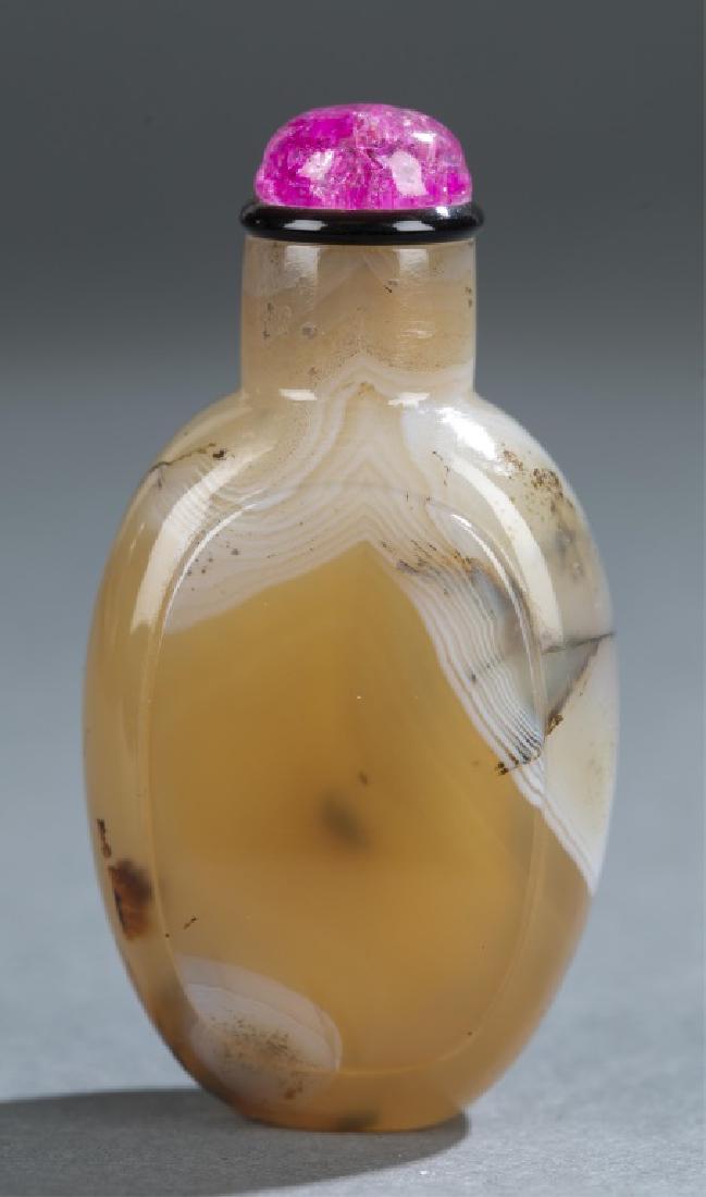 Agate snuff bottle.: A Chinese honey agate snuff bottle. c.1750-1860. Honey with white band. Flattened ovoid form with raised panels on both sides, straight neck, on oval base, with pink glass stopper. 2 1/4"._x000D_ Prov