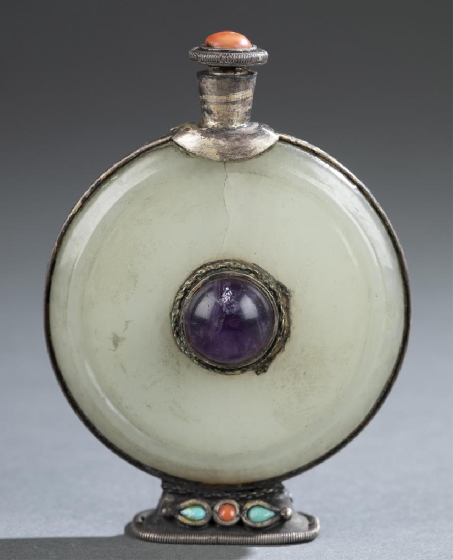 Mongolian snuff bottle.: A Mongolian snuff bottle. Metal mounted jade plaques with semi-precious stone inlays. Flattened round form with metal mounted foot and neck, and matching stopper. Crack to jade on one side. 3â€h.