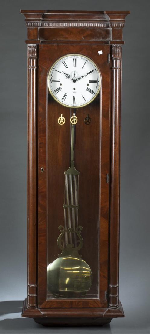 Trend mahogany regulator wall clock, 20th century.: A Sligh Trend mahogany regulator wall clock. Zeeland, Michigan. 20th century. Regulator wall clock with carved architectural decoration mahogany case and Roman numeral dial. Includes pendulum, not wei