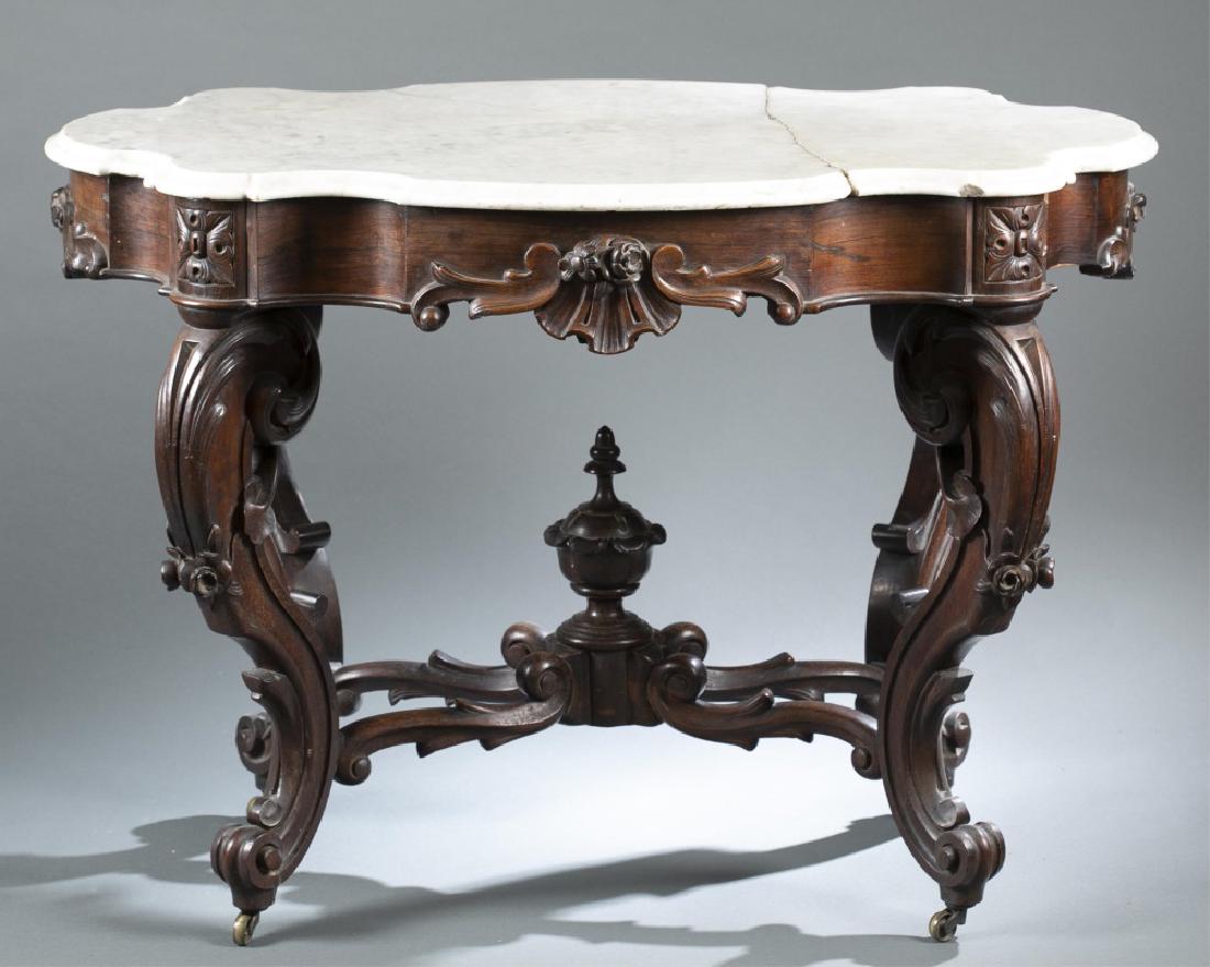 Meeks style, parlor table, circa 1840.: A J. & J.W. Meeks style, parlor table. Circa 1840. White marble turtle-top shaped on mahogany table on casters. Carved decoration of scrolling, floral, shell, and urn. White marble top is broken into 