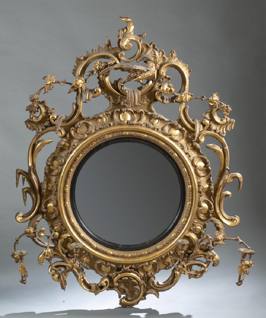 Girandole convex mirror, circa 1820s.: A girandole convex mirror. Circa 1820s. Carved phoenix atop mirror, flanked by decorative scrolling and chinoiserie. Circular convex mirror with reeded slip and convex gilded moldings. Two candle arms