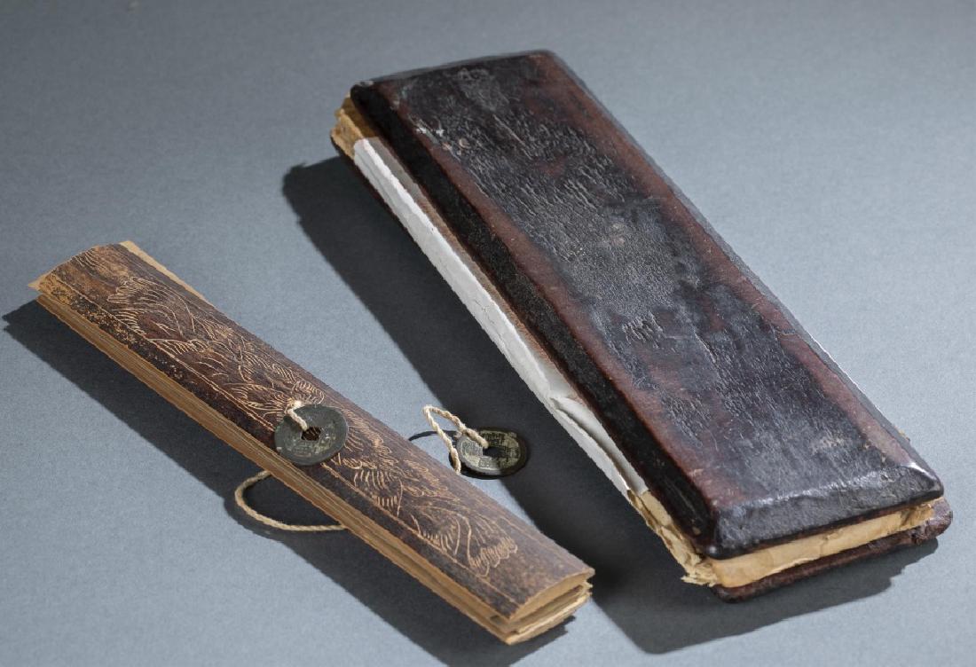 2 Himalayan inscription books.: A group of two Himalayan inscription books. Circa mid 18th century. ++ Nepalese inscription book possibly from Kathmandu. Has two wooden covers with inside having painted deities in the clouds. Covers