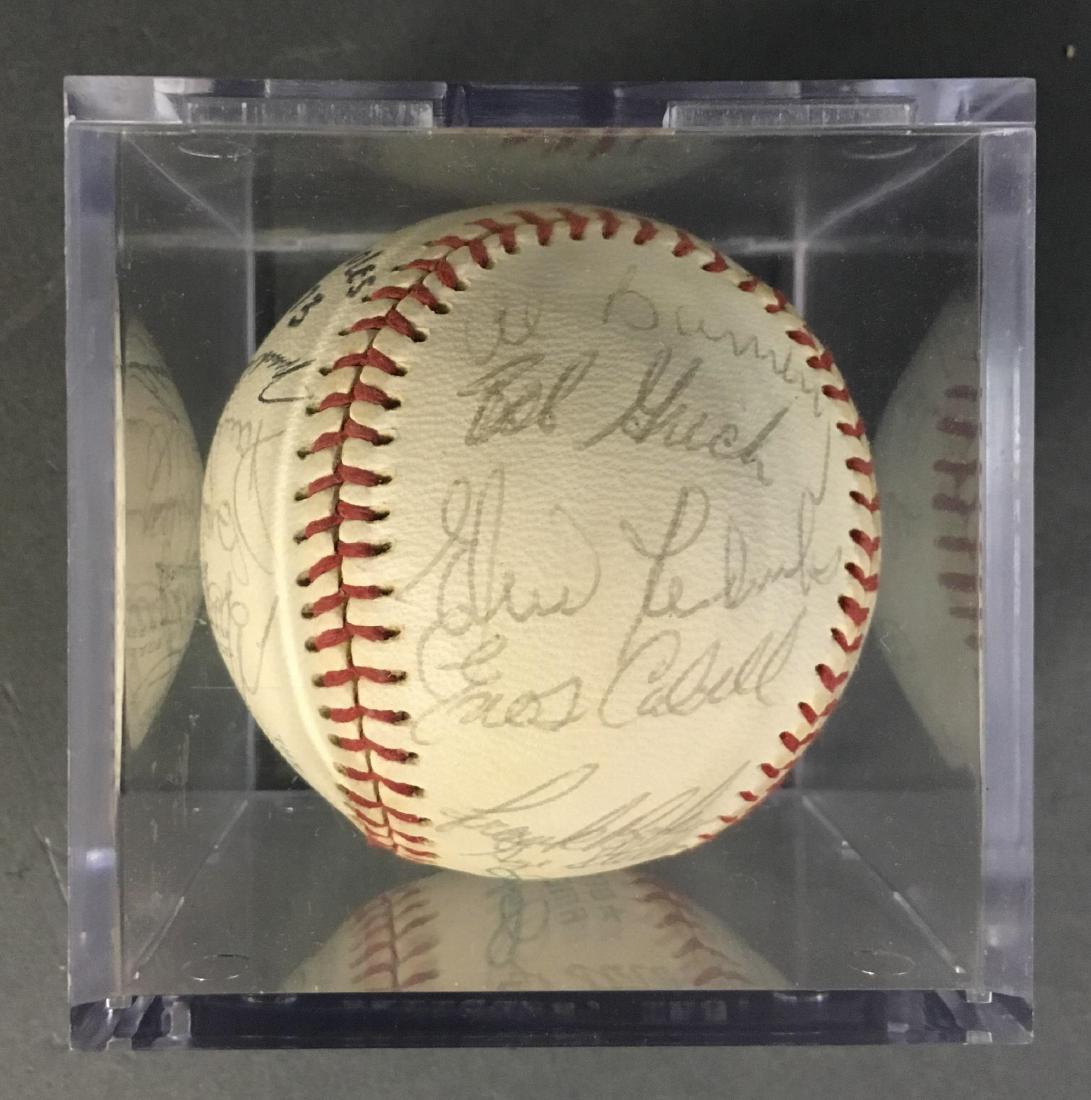 1973 Orioles team signed baseball.: 1973 Orioles team baseball signed 25 times. North panel: Brooks Robinson, Mark Belanger, and 2 others._x000D_ South panel: Rich Coggins, Doyle Alexander, Bob Reynolds, Jim Palmer, and 2 others. East p