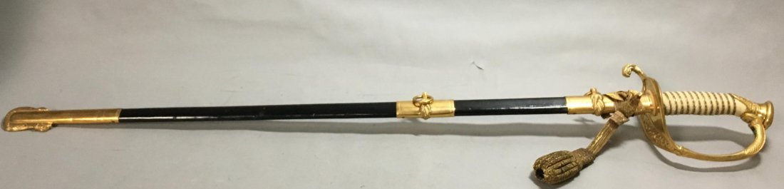 Vietnam Era Model 1850 Naval Officer's Sword: Vietnam Era Model 1850 Naval Officer's Sword. Etched E.S. Meyer, West Germany on ricasso. USN marked on guard and on blade. With original brass and leather bpund sheath. 36" long