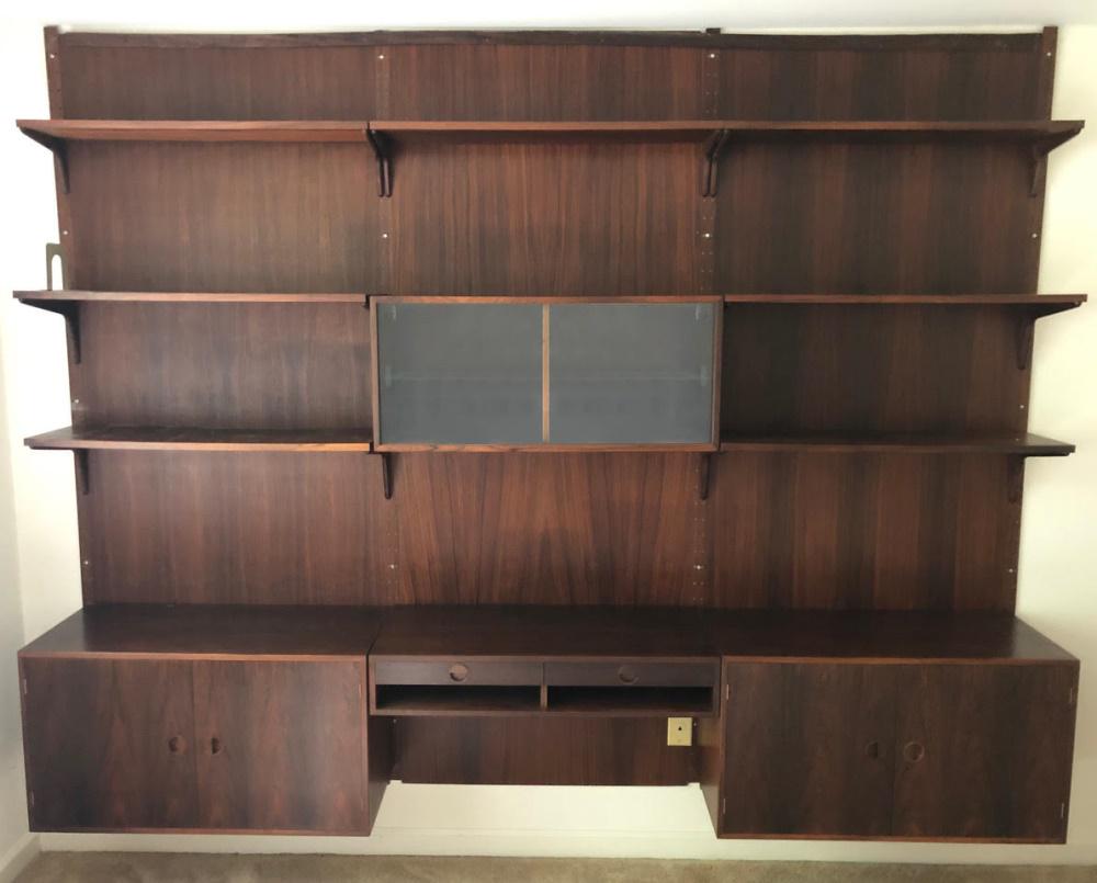 Hansen & Guldborg, rosewood wall unit.: A Hansen and Guldborg rosewood wall unit. Danish. Mid-20th century. Rosewood wall unit and book case. Seven open shelves with center glass front cabinet. Can be disassembled for transportation. Marked