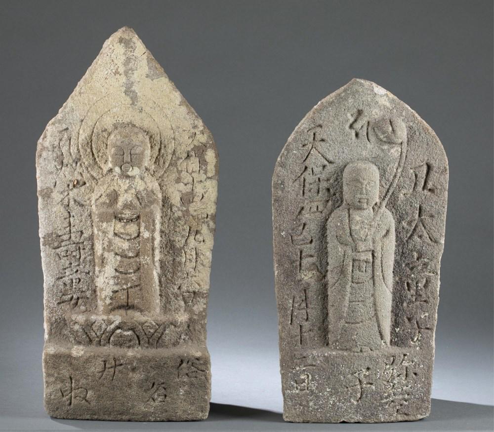 2 Japanese stone Buddhist steles, 19th c.: A group of two Japanese carved stone Buddhist Steles. 19th century. ++ Jizo Bosatsu in the guise of a monk surrounded by inscriptions. 20" x 8 1/2" x 5 1/2". ++ Jizo Bosatsu holding a long-stemmed lot