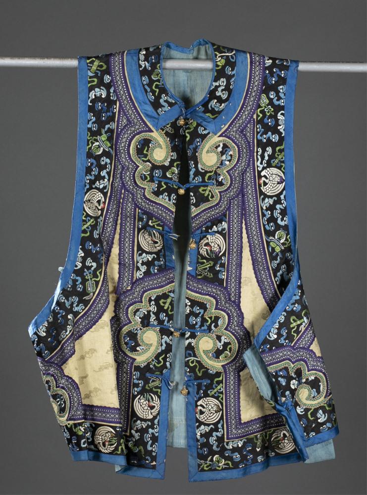 Chinese silk embroidery vest, 19th/20th c.: A Chinese silk embroidery vest (majia). 19th/20th century. Yellow damask silk with embroidery trim. Five gold tone buttons, two button loops are damaged. Geometric trim in yellow, green, blue, and pur