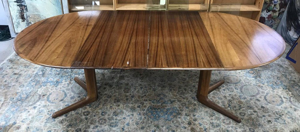 Dyrlund, extension table, 20th century.: A Dyrlund extension table. Danish. Circa 1960s. Circular table top , on split pedestal base, with two leaves that extend into oval table top. Marked on bottom. Wear on table top and around edge consis