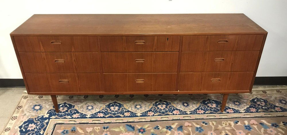 Danish teak credenza, 20th century.: A Dyrlund extension table. Danish. Circa 1960s. Circular table top , on split pedestal base, with two leaves that extend into oval table top. Marked on bottom. Wear on table top and around edge consis