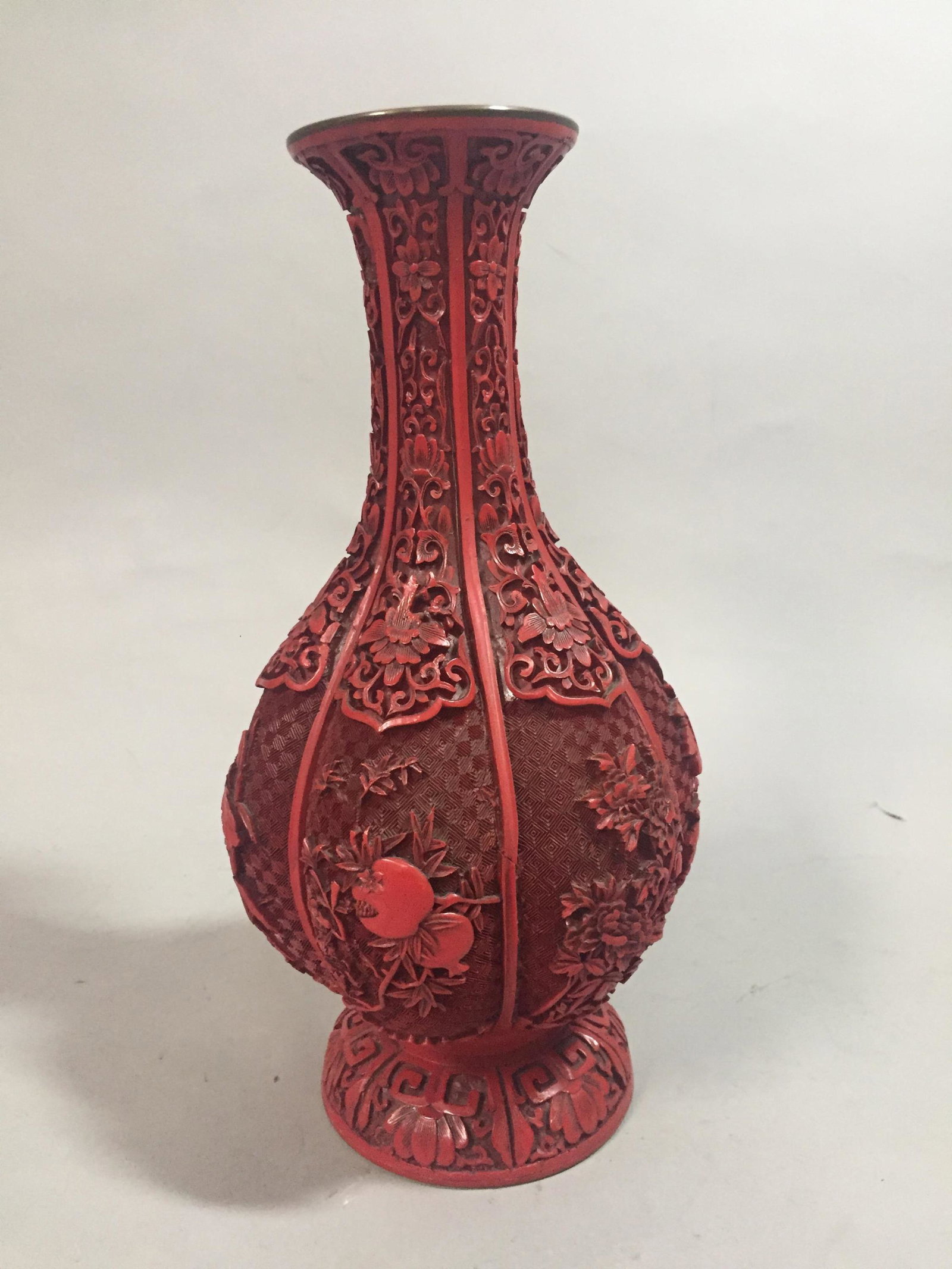 Carved Cinnabar Chinese Vase.: Carved Cinnabar Chinese Vase. Adorned with pomegranates and articulated foliate design. Stands 11 1/2" tall.