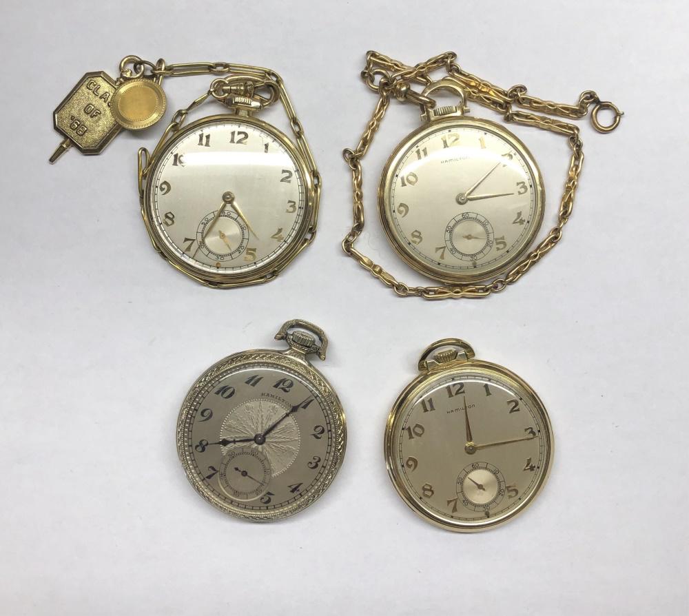 4 Hamilton 14k gold fill pocket watches.: A group of four Hamilton 14k gold fill pocket watches. ++ Hamilton 912. Open face with silver tone case and star decoration in background. Marked on face "Hamilton." Watch in working order. Diameter 1