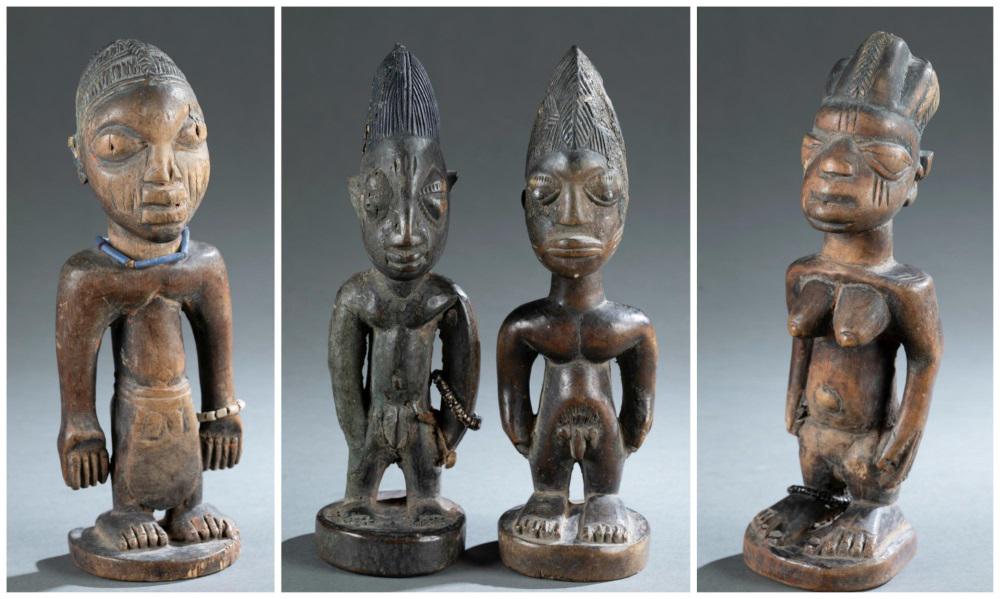 4 Yoruba Ibeji Figures. 20th c.: A group of four Yoruba Ibeji figures. Nigeria. 20th century. ++ Female figure. 2 3/4" x 2 3/4" x 9". ++ 2 male figures. Piece 1: 9 1/4" x 2 3/4" x 3". Piece 2: 9 1/4" x 3" x 2 7/8". ++ Male figure. 9 