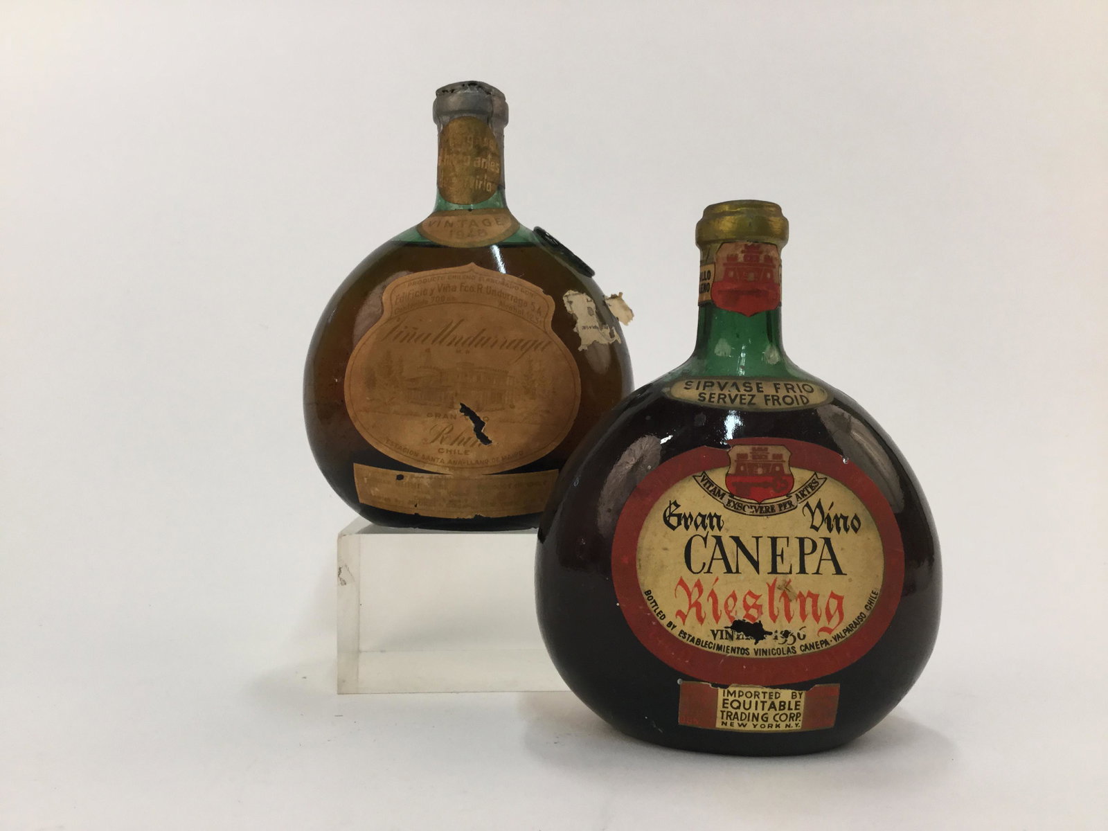 2 Chilean Wines.: Two bottles of wine from Chile. ++ Canepa Riesling. ++ 1948 Vina Undurraga._x000D_ Condition: Heavy wear, discolorations, and abrasions to bottles.