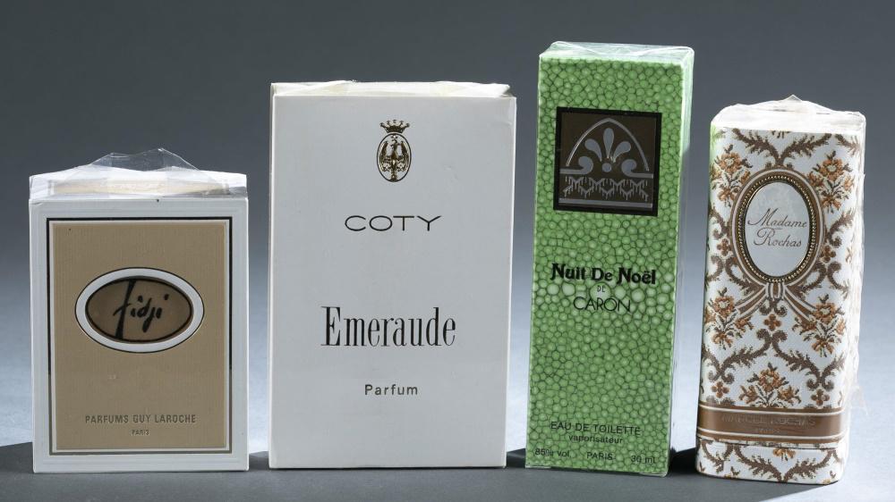 4 French perfume bottles.: A group of four French perfume bottles. Unopened in original plastic wrapping. ++ Caron "Nuit de Noel" eau de toilette. 1 fl. oz. 5 1/4" x 2". ++ Marcel Rochas "Madame Rochas" perfume bottle. 4 1/2" x