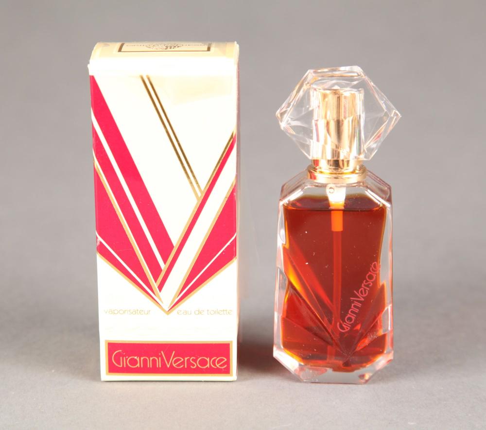 Gianni Versace, eau de toilette.: A Gianni Versace, eau de toilette and box. Circa 1980s. Plastic geometric top, unsealed, gold colored atomizer, with geometric beveled bottle. Marked on bottle and bottom. Top of box marked "Venice Si