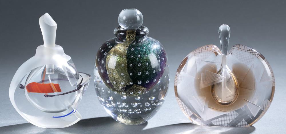 3 Art glass perfume bottles.: A group of three art glass perfume bottles. 20th century. American. ++ Robert Eickholt (American, b.1949) art glass perfume bottle. Sphere shaped clear glass stopper. Inner body made of green and gold