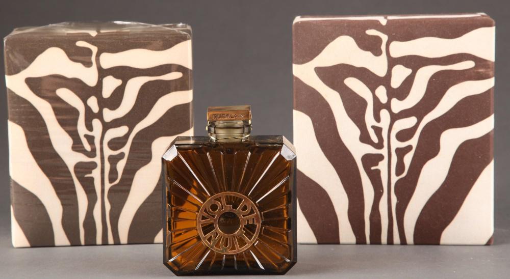 2 Guerlain, "Vol de Nuit", parfum.: A group of two Guerlain "Vol de Nuit" parfum bottles and boxes. 1979-1984. Glass designed by Pochet et du Courval. Square top, sealed, on smoky brown square-shaped glass bottle. Marked on top, bottle,
