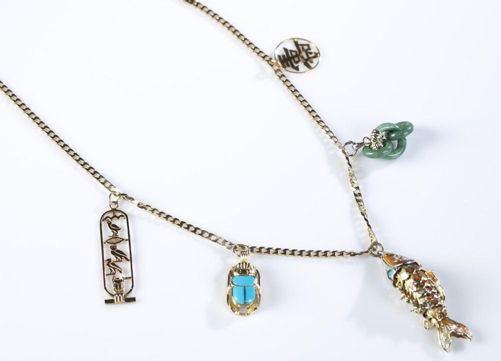 14k Gold charm necklace.: A14k gold charm necklace. Five charms on flat 14k chain. Marked "14k" on clasp. Charms include, 18k jade rings, 14k Chinese character, 18k gold cartouche, 18k turquoise scarab beetle, and an 18k fish.