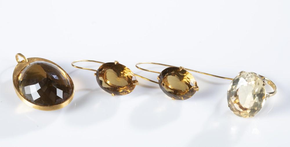 3 Pieces of 18k gold quartz jewelry.: ++ A n oval cut lemon quartz ring in an 18k yellow gold setting. Stamped "750." Size 6. Total weight: Approx, 7.6g. ++ A pair of oval cut citrine quartz drop earrings in 18k yellow gold settings and F