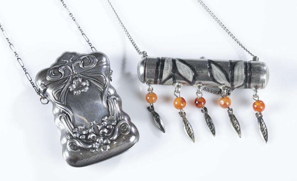 2 Silver tone matchstick cases.: A group of two silver tone matchstick cases. ++ Art Nouveau style silver tone matchstick case. Hinged top with floral and vine decoration. Chain: 30". Case: 2 3/4" x 1 1/2". Approximately 39.9 g. ++ S