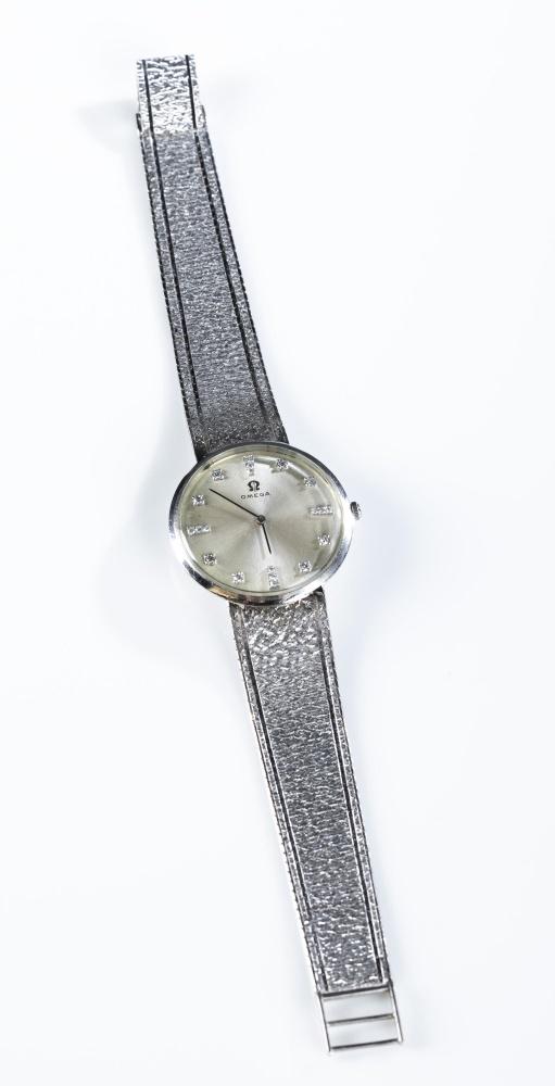 Omega 14k white gold and diamond wristwatch.: A ladies Omega 14k white gold and diamond wristwatch. Round silver face inset with small diamonds in a 14k white gold case. Bracelet is 14k white gold with folding clasp. Seventeen jewel Omega 620 mov