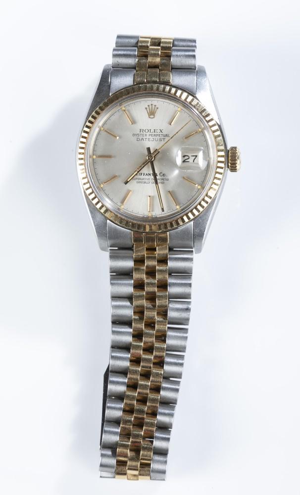 Men: A Men's Rolex and Tiffany & Co. Oyster Perpetual Datejust bracelet watch. Round face with calendar window in stainless steel case with gold tone bezel. 18k gold and stainless steel bracelet band. Twen