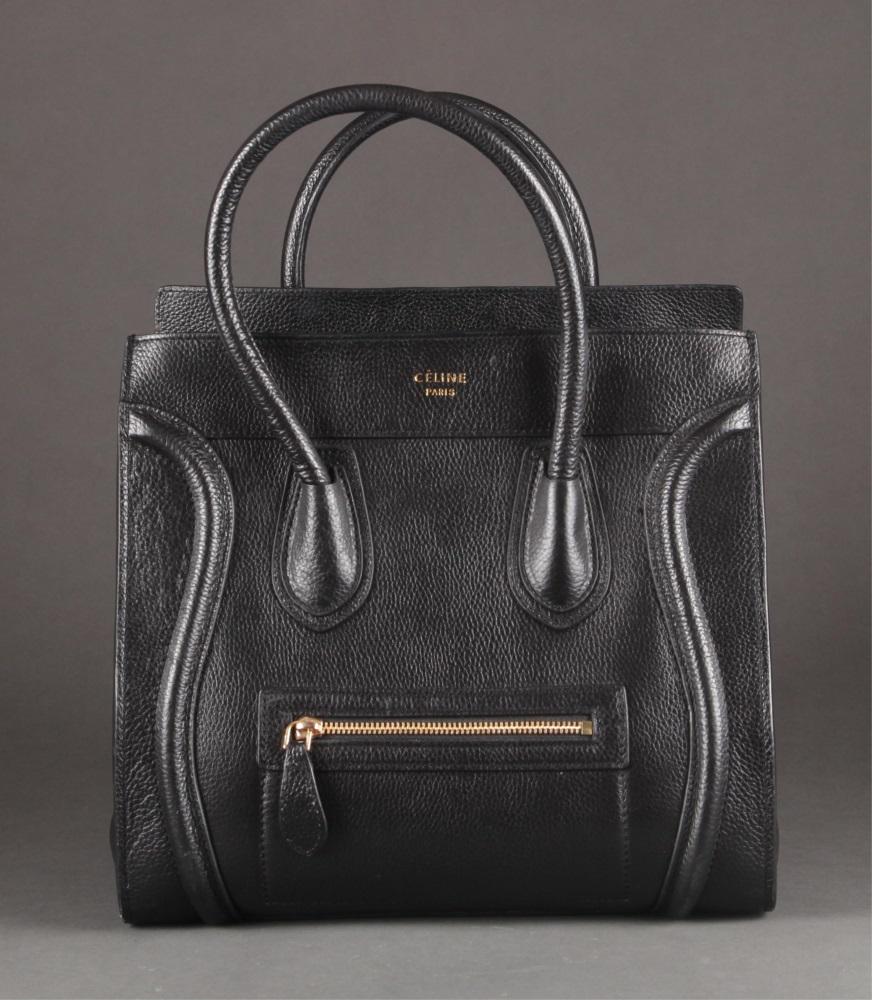 Celine, mini luggage handbag.: A Celine mini luggage handbag. Black leather tote with dual rolled handle. Exterior zipped pocket with three interior pockets and zipped closure. Gold tone hardware. Marked near top center "Celine Par