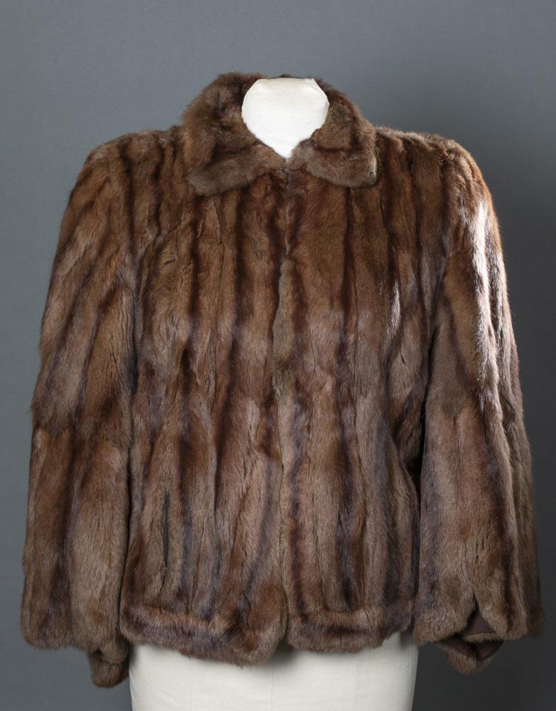 Brown Mink Fur, New York Fur Shop, Cape.: A brown mink fun New York Fur Shop cape having two pockets and a single fastener. Crepe lining monogrammed EG. Tear in right shoulder seem. Length: Approx, 26".