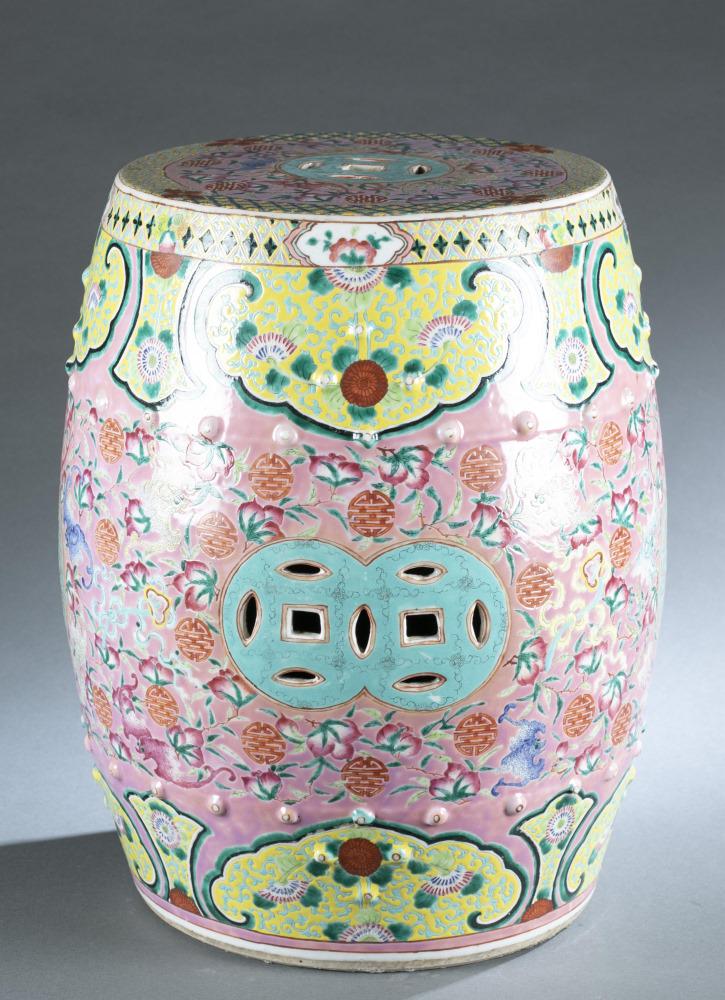 Chinese famille rose garden stool, early 20th c.: A Chinese famille rose porcelain garden stool. Overall decoration of flowers and geometric patterns with coin symbols on top and sides. Approx: 18 1/2" x 13 1/2"._x000D_ Provenance: Requires third par