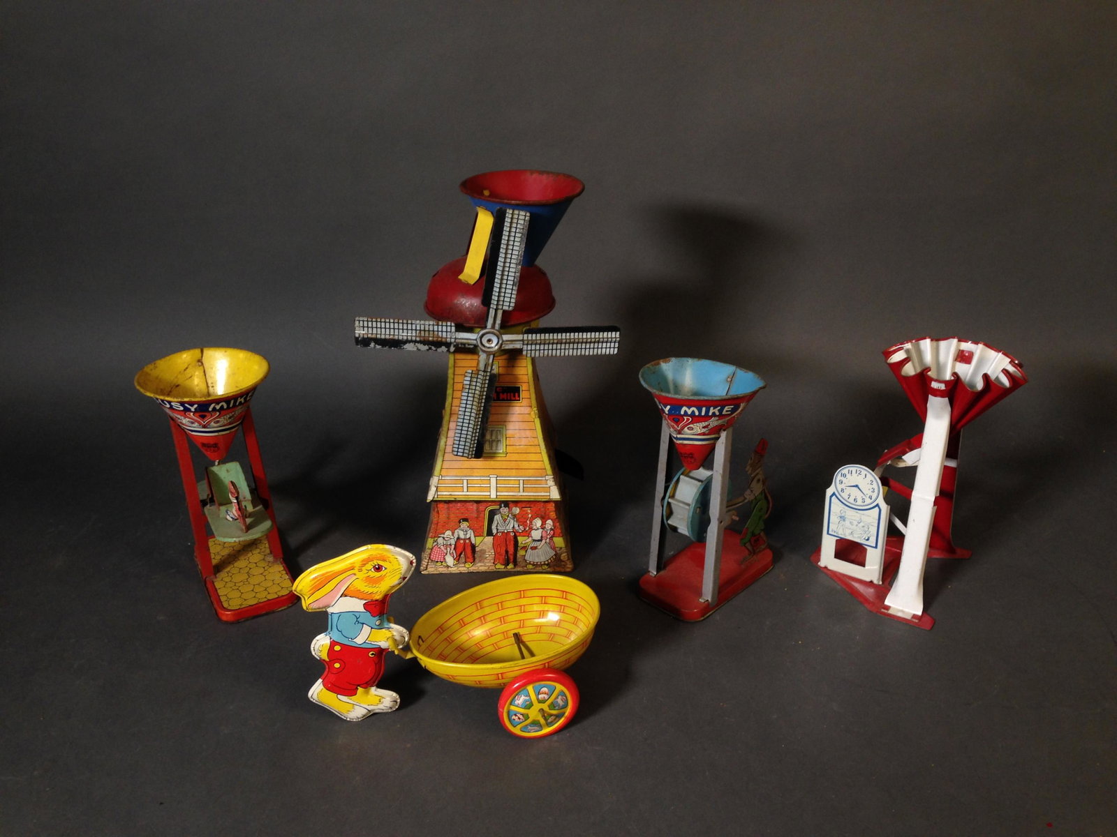 Five Vintage Tin Litho J. Chein & Other Sand Toys: Five Vintage Tin Litho J. Chien & Co. & Other Sand Toys ++ Two J. Chein "Busy Mike" sand toys, 7.5" tall ++ J. Chein rabbit push basket, 5.5" x 8" ++ "Mac" Dutch Mill toy, 12" tall_x000D_ Condition: B