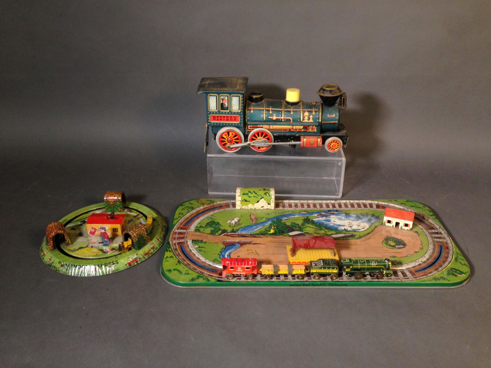 Two Tin Litho Windup Train Sets, Inc. MARX: Three Tin Litho Windup Train Sets, Inc. Louis MARX & Co. ++ Marx Honeymoon Express, 9" across ++ Ranger Steel Cooperation tin litho train tracks and clockwork four piece train set, set 22" x 11" ++ Ja