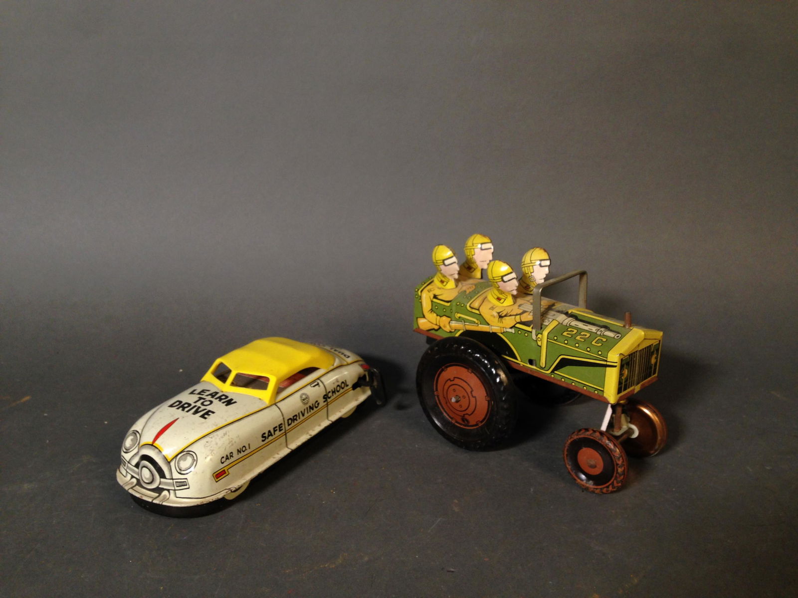 Two Vintage MARX Tin Litho Wind Up Toys: Two Vintage Louis MARX & Co. Tin Litho Wind Up Toys ++ 22C Jumpin Jeep Tin Wind Up Toy, Marx logo on left side, 5.5" x 4.25" x 4" ++ Safe Driving School Dual Control Driver Training Car, 7" x 3.5" x 2