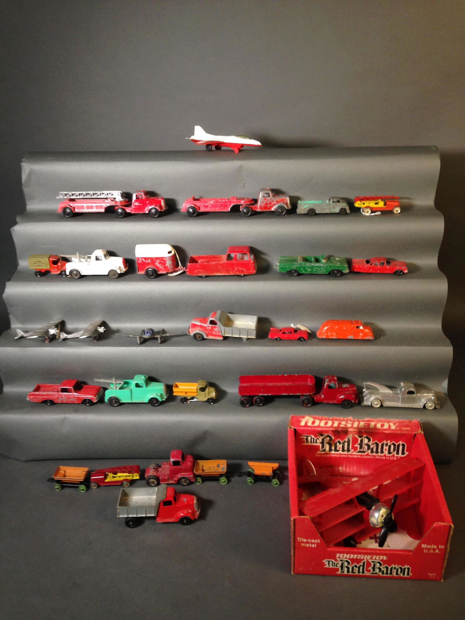 29 TootsieToy Die-Cast Cars & Planes: 27 TootsieToy Die Cast Cars & Planes ++ Die Cast and Plastic Red Baron 3260 in box ++ Two metal wheeled fire water tower trucks ++_x000D_ Condition: All have chipped paint and wear on wheels. One truc